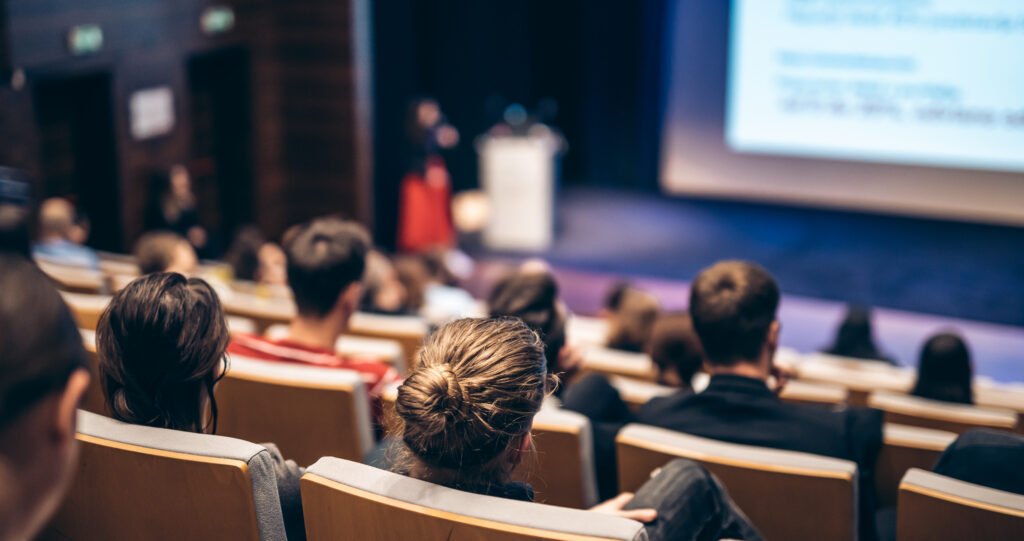 Woman giving presentation on business conference event.